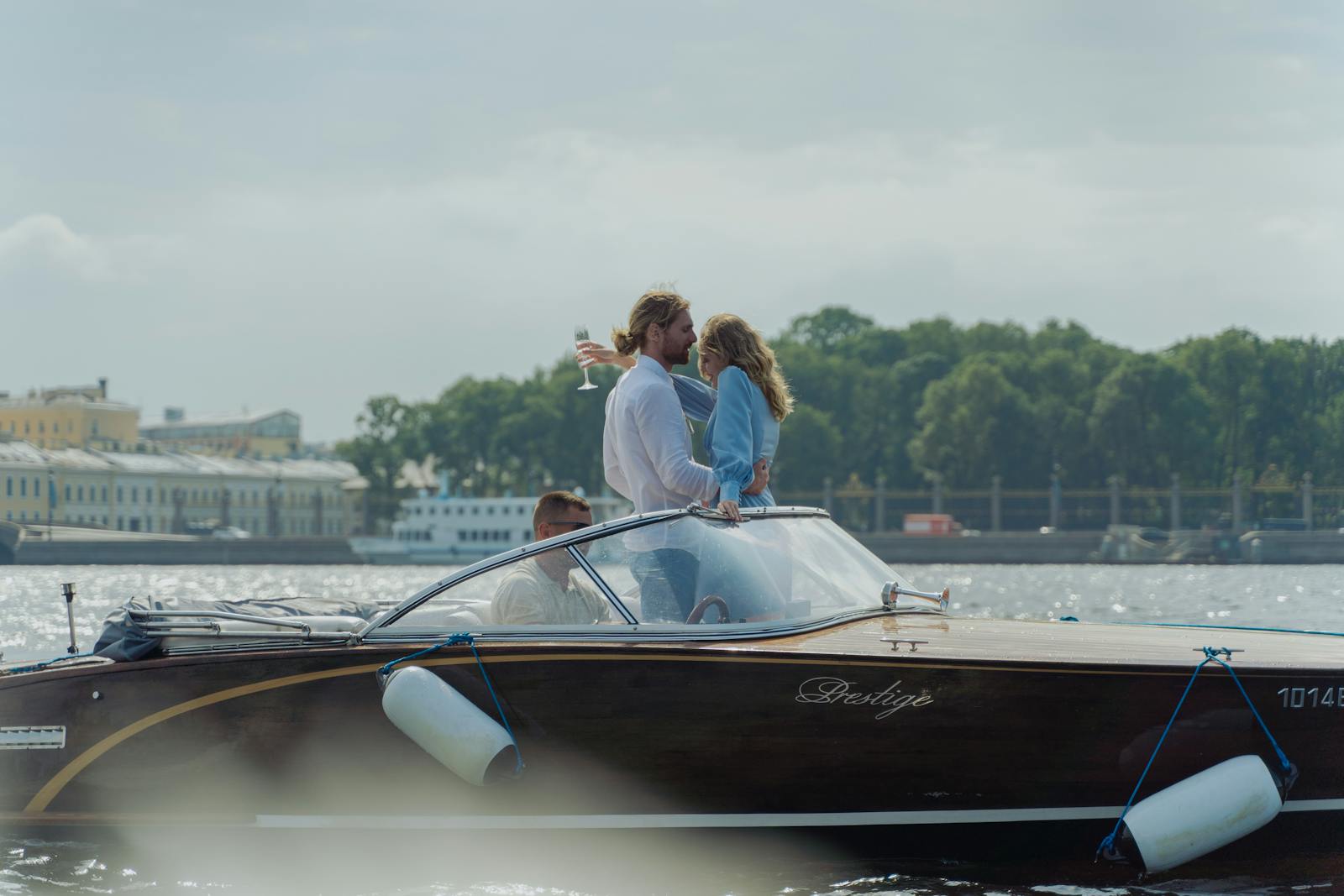 A couple enjoys a romantic moment on a luxury boat ride, capturing bliss and luxury.
